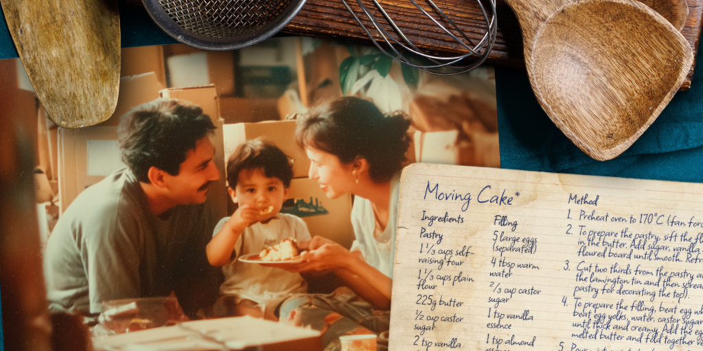 A family eating cake with moving boxes in the background